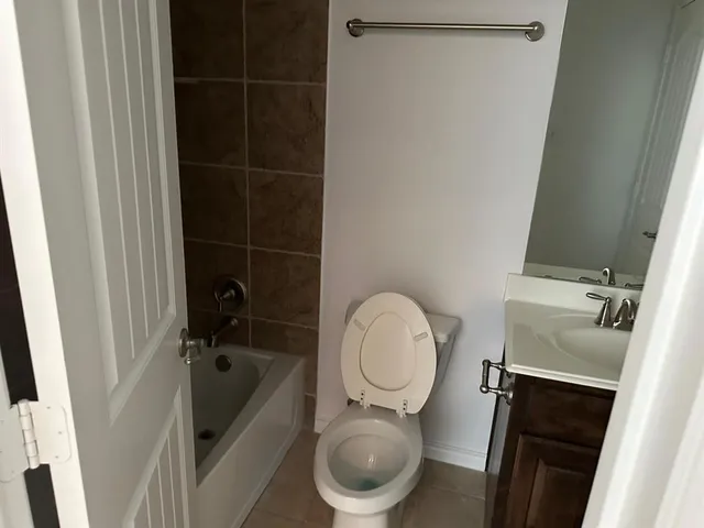a white toilet sitting next to a sink