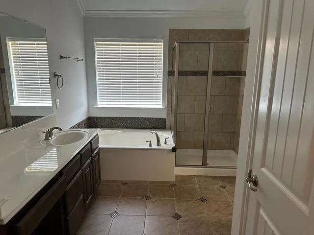 a bathroom with a tub sink and mirror
