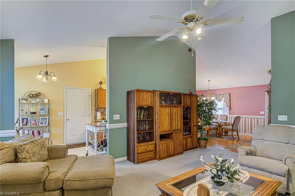 7503 Bartonshire Court Oak Ridge, NC 27310 - Photo 14 of 24 Open living room with vaulted ceiling. This offers views to dining and breakfast area.
