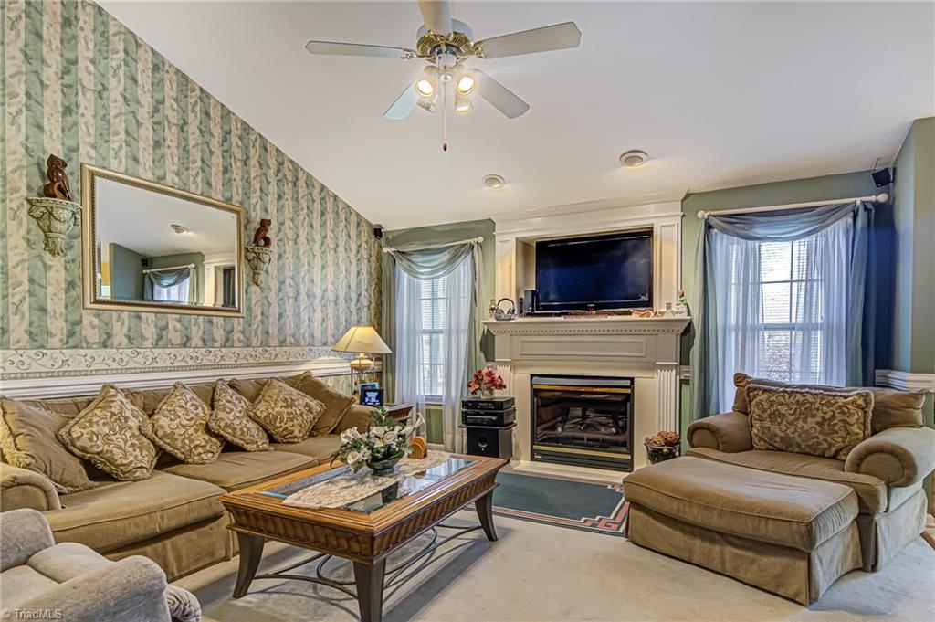 7503 Bartonshire Court Oak Ridge, NC 27310 - Photo 15 of 24 Living room with gas log fireplace. Built-in fan for extra warmth!