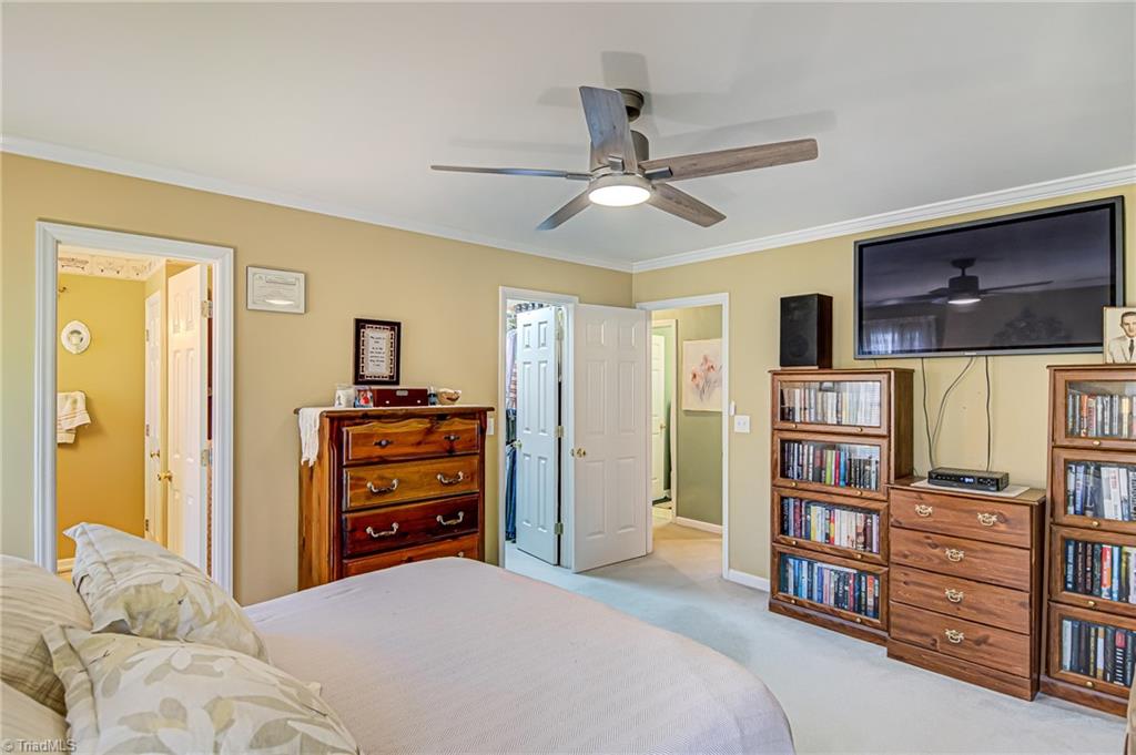 7503 Bartonshire Court Oak Ridge, NC 27310 - Photo 16 of 24 Primary Bedroom with private bath and walk-in closet space.