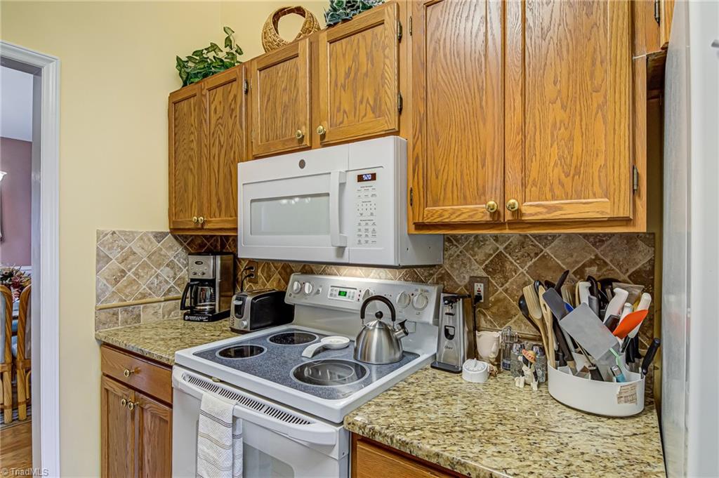 7503 Bartonshire Court Oak Ridge, NC 27310 - Photo 9 of 24 Kitchen with slide-in oven and built-in microwave.