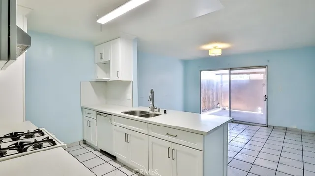 a kitchen with a sink cabinets and appliances