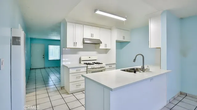 a kitchen with a sink cabinets and appliances
