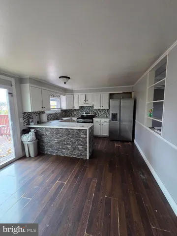 a kitchen with stainless steel appliances a refrigerator sink and wooden cabinets