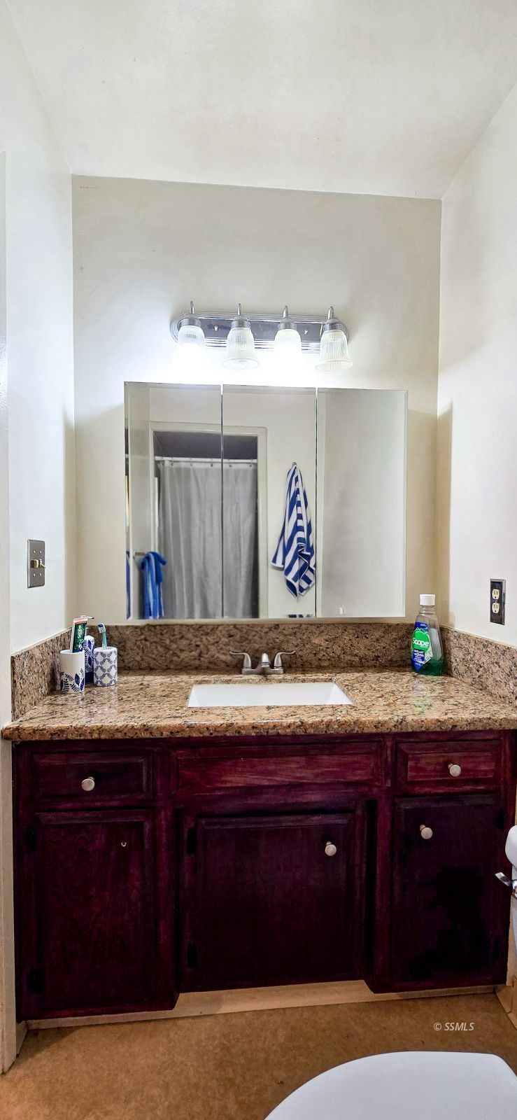 813 West Alene Avenue Ridgecrest, CA 93555 - Photo 20 of 26 a bathroom with a granite countertop sink and a mirror
