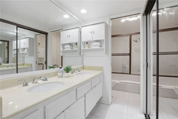 a bathroom with a double vanity sink mirror and double