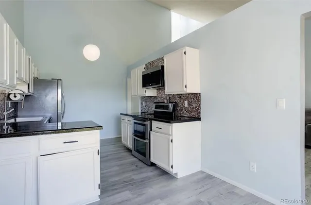 a bathroom with a granite countertop sink a toilet and a mirror