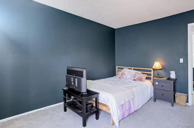 a bathroom with a sink a toilet a mirror and shower curtain