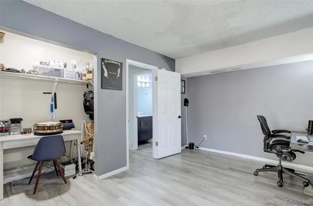 a livingroom with a flat screen tv and a window