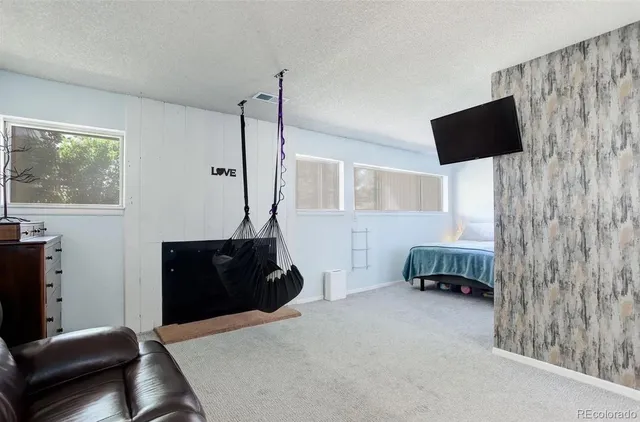 a bedroom with a bed and a flat tv screen