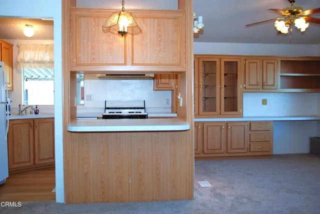 a kitchen with a refrigerator a stove a sink and a window