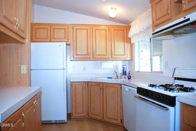 a kitchen with a sink stove and refrigerator