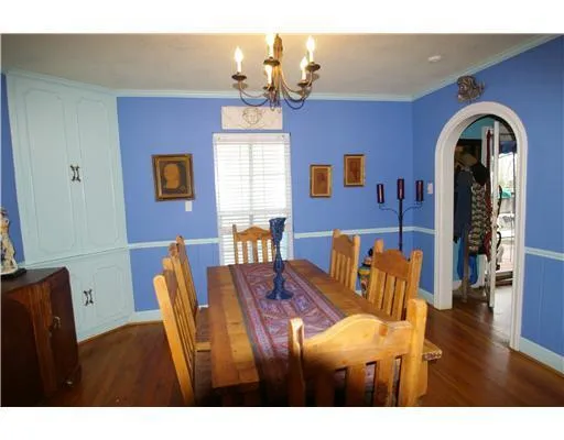 a view of livingroom and dining room with furniture wooden floor and chandelier