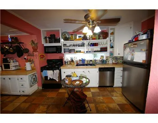 a kitchen with stainless steel appliances granite countertop a stove and a refrigerator