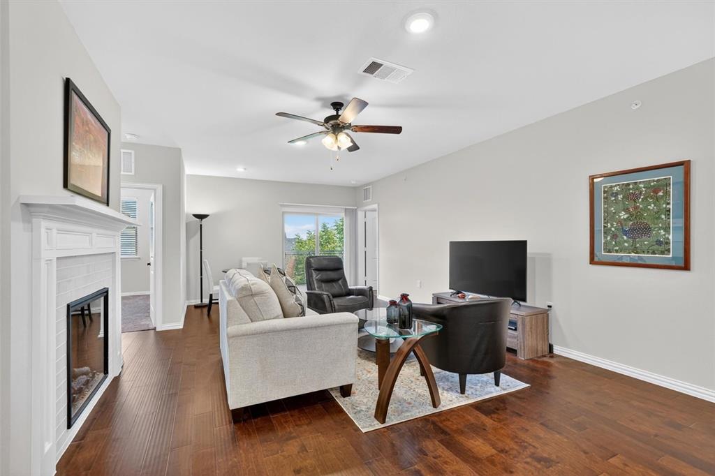 651 Watters Road, Unit 5305 Allen, TX 75013 - Photo 2 of 40 a living room with furniture fireplace and a flat screen tv