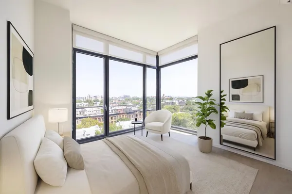 a bedroom with a large bed and a large window