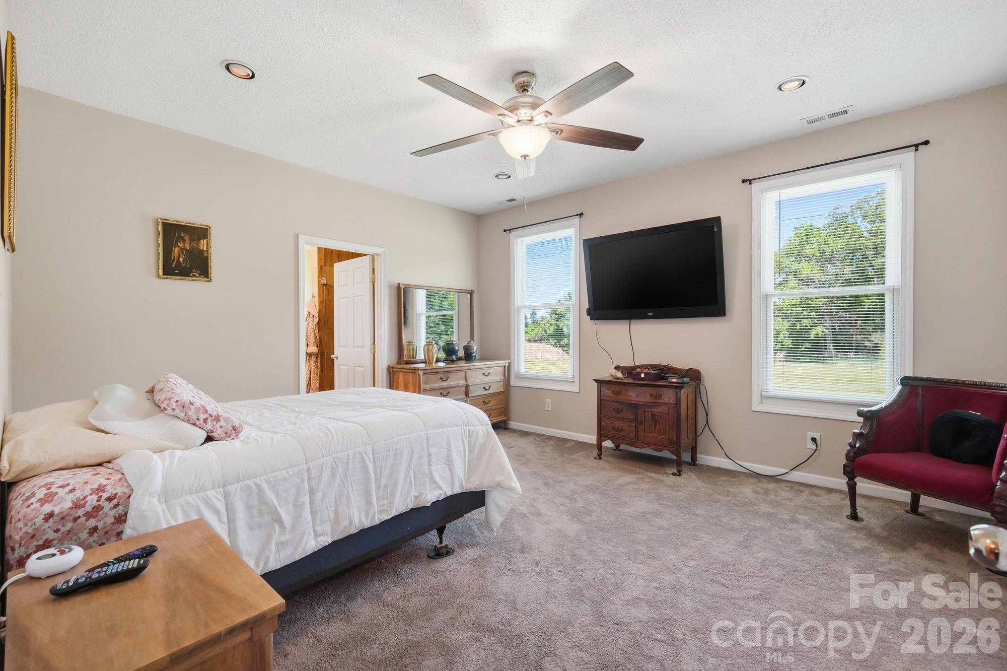 4415 Old Monroe Marshville Road Wingate, NC 28174 - Photo 9 of 28 a bedroom with a bed and a flat screen tv