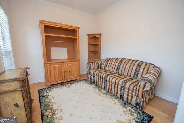 a bedroom with a bed and painting on the wall