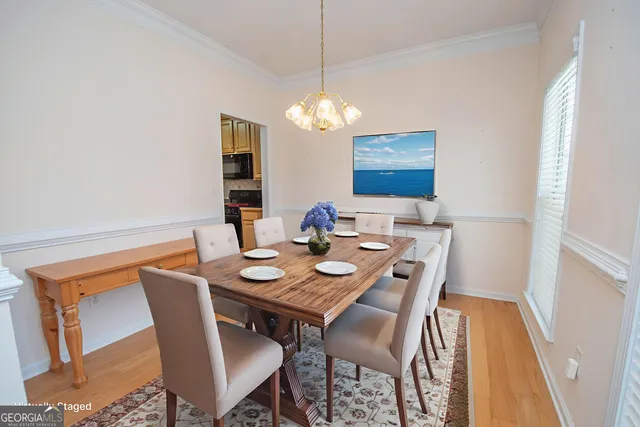 a view of a dining room with furniture and wooden floor
