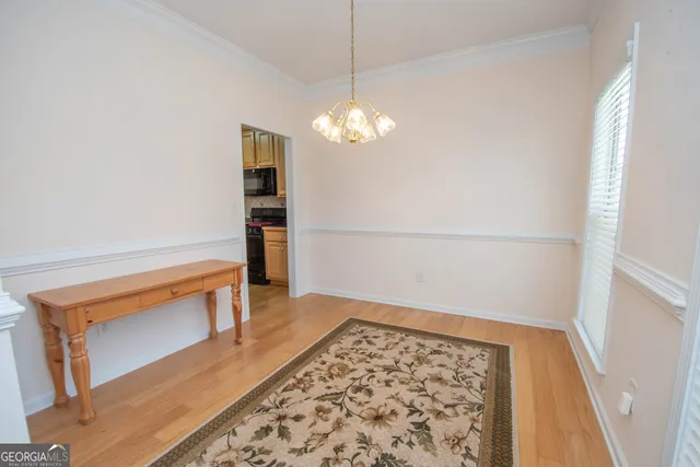 a view of a room with wooden floor and staircase