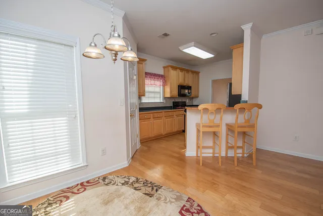 a view of a dining room with furniture and wooden floor