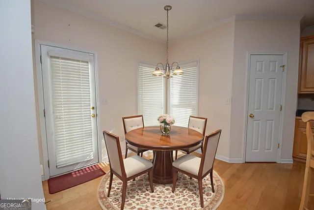 a view of a dining room with furniture and window