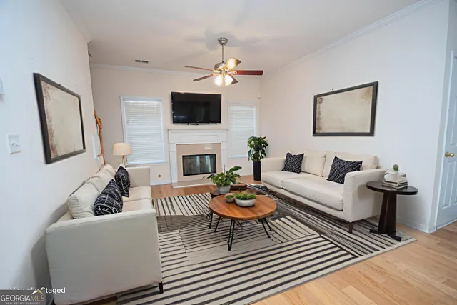 a living room with furniture a fireplace and a flat screen tv