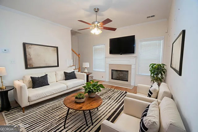 a living room with furniture a fireplace and a flat screen tv