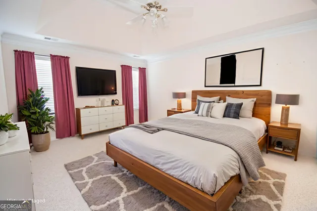 a bedroom with a bed and a flat screen television