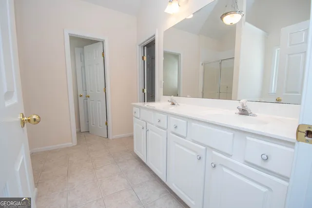 a spacious bathroom with a sink and a mirror