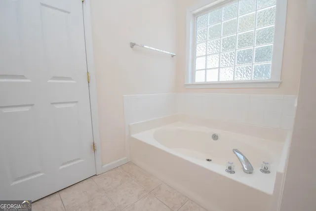 a white bath tub sitting next to a window
