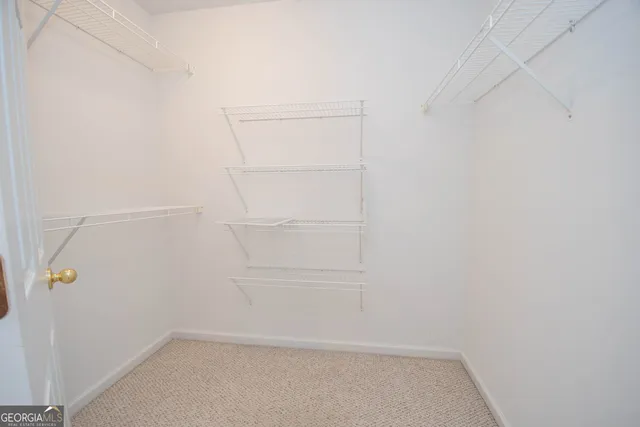 a bedroom with a bed and a potted plant