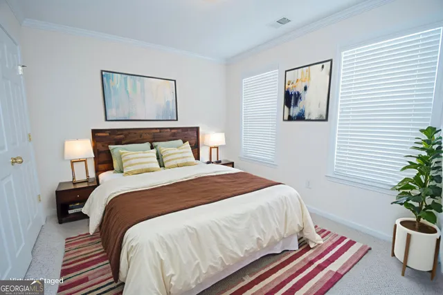 a bedroom with a bed and a potted plant