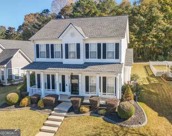 a view of a patio with couches chairs and wooden floor