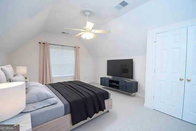 an empty room with a ceiling fan and a window