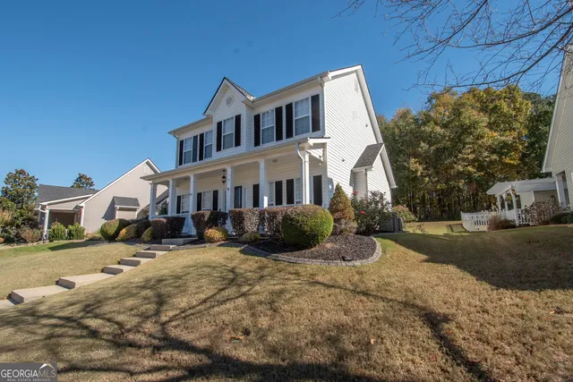 a view of a big house with a yard