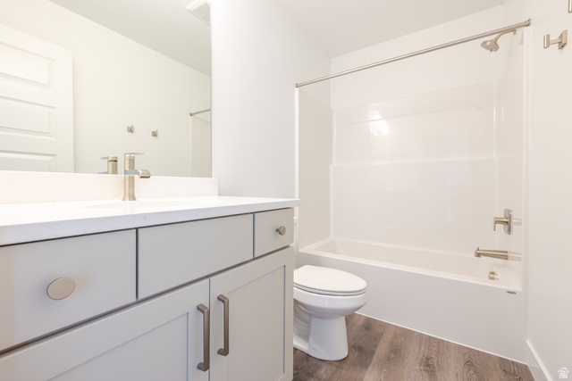 5287 South Acacia Drive, Unit 714 Mapleton, UT 84664 - Photo 16 of 21 Bathroom vanity with a white countertop and undermount sink, brushed nickel faucet, light gray cabinetry, and wood-finish flooring