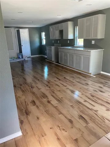 a kitchen with granite countertop a stove and cabinets