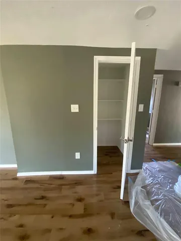 a view of a livingroom with wooden floor and door