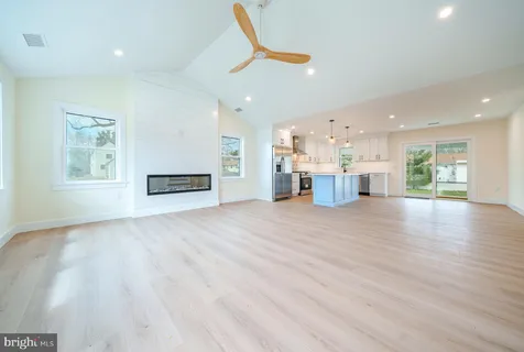 a view of a kitchen with a sink and a refrigerator