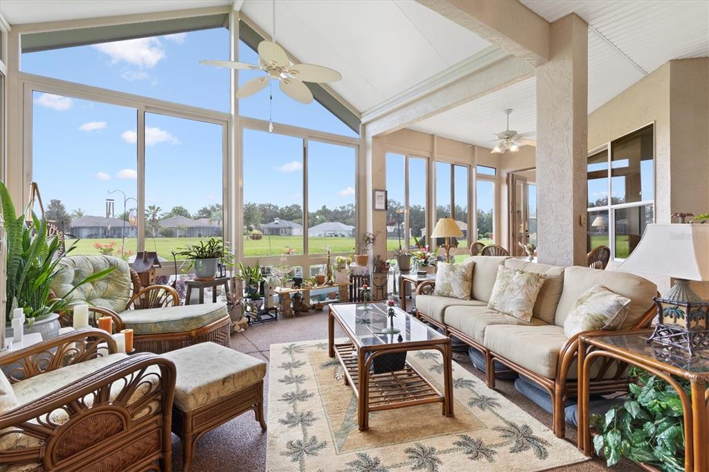 a living room with furniture and large windows