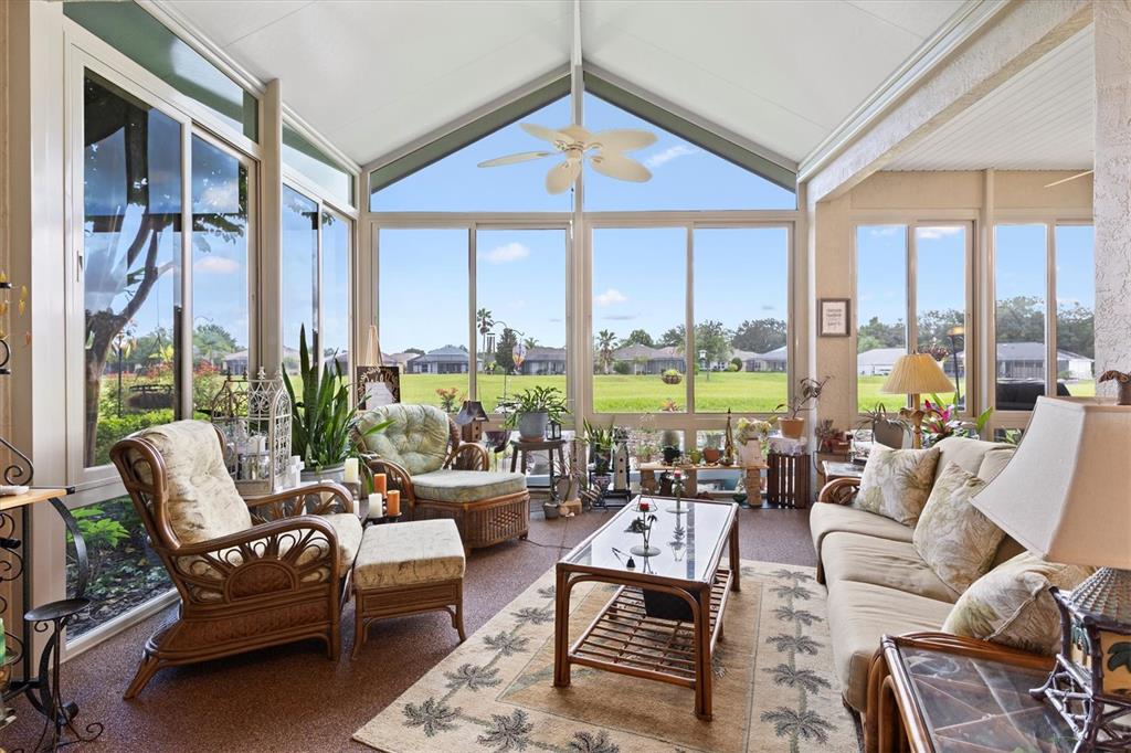 11839 Southeast 173rd Ln Road Summerfield, FL 34491 - Photo 18 of 49 a living room with furniture and floor to ceiling windows