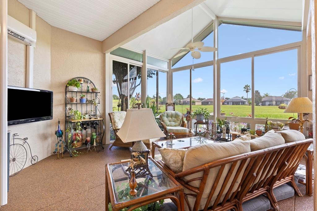 11839 Southeast 173rd Ln Road Summerfield, FL 34491 - Photo 20 of 49 a living room with furniture a floor to ceiling window and a flat screen tv