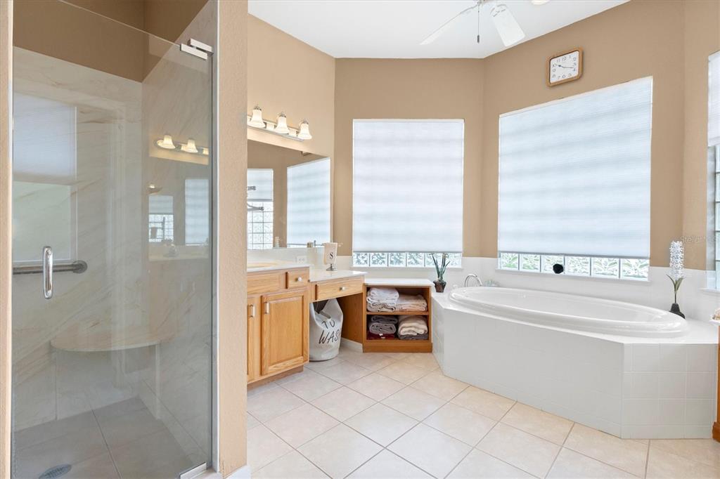 11839 Southeast 173rd Ln Road Summerfield, FL 34491 - Photo 26 of 49 a spacious bathroom with a tub sink and mirror