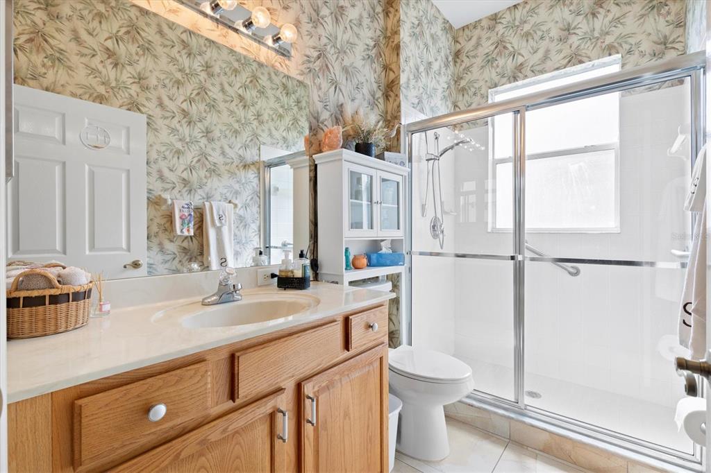 11839 Southeast 173rd Ln Road Summerfield, FL 34491 - Photo 30 of 49 a bathroom with a sink a toilet and shower