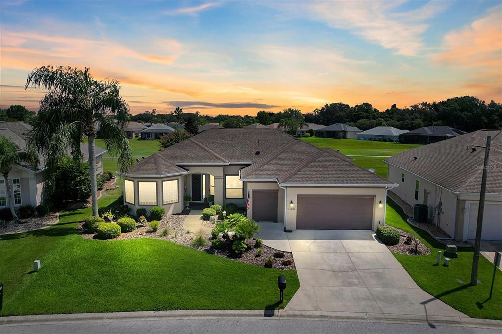 11839 Southeast 173rd Ln Road Summerfield, FL 34491 - Photo 3 of 49 a front view of a house with a yard and potted plants