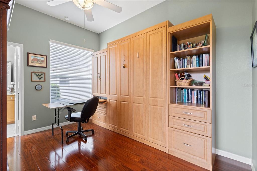 11839 Southeast 173rd Ln Road Summerfield, FL 34491 - Photo 31 of 49 a view of a workspace with furniture and a bookshelf