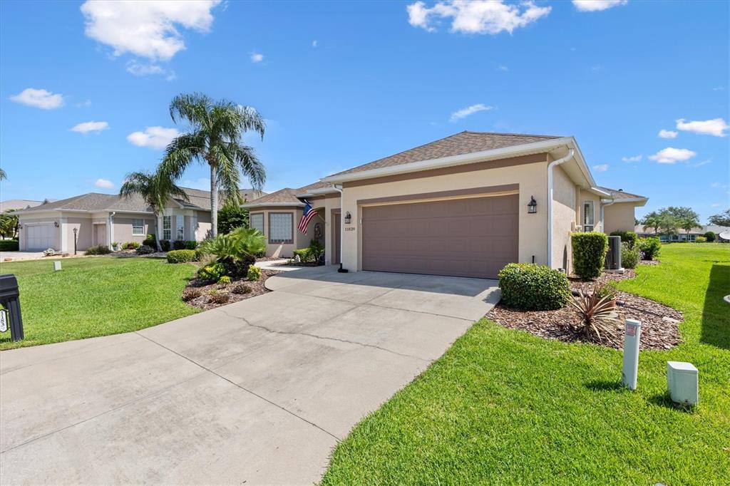 11839 Southeast 173rd Ln Road Summerfield, FL 34491 - Photo 5 of 49 a front view of a house with a yard and garage