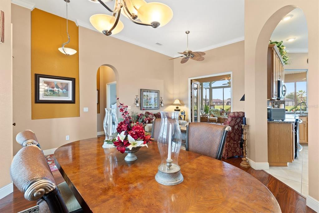 11839 Southeast 173rd Ln Road Summerfield, FL 34491 - Photo 10 of 49 a dining room with wooden floor and chandelier